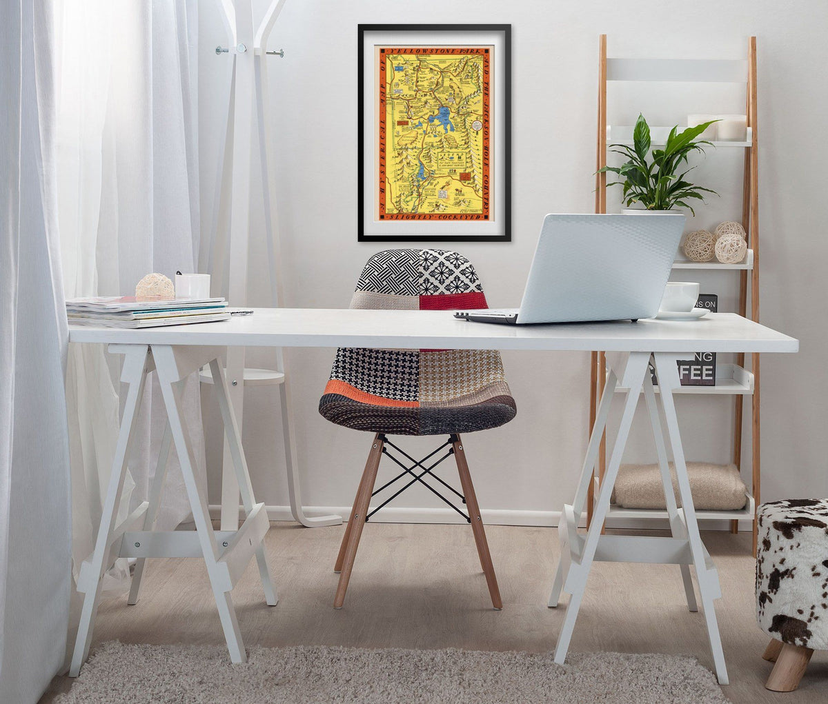 Hysterical Map of Yellowstone 1936 print framed above a white desk in a home office