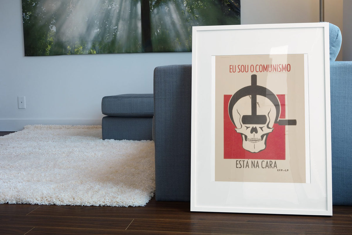 I Am Communism poster leaning beside a blue sofa