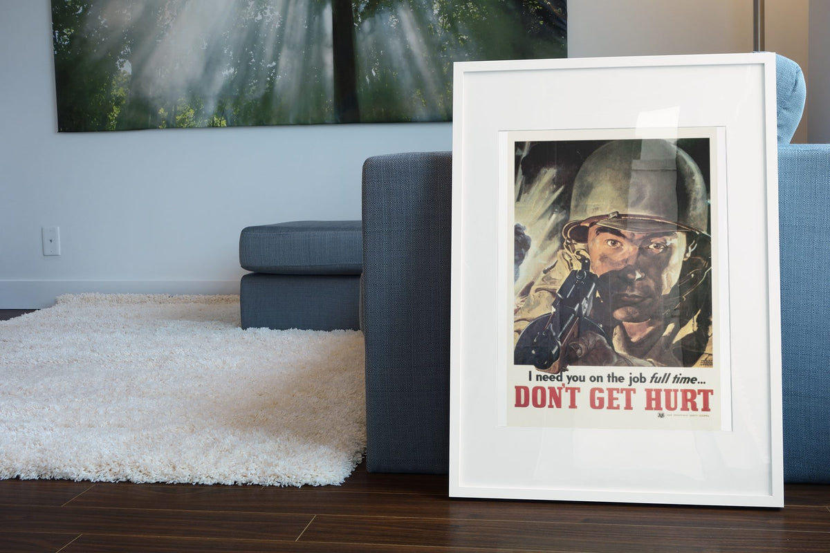 I Need You on the Job Full Time Dont Get Hurt poster leaning beside a blue sofa
