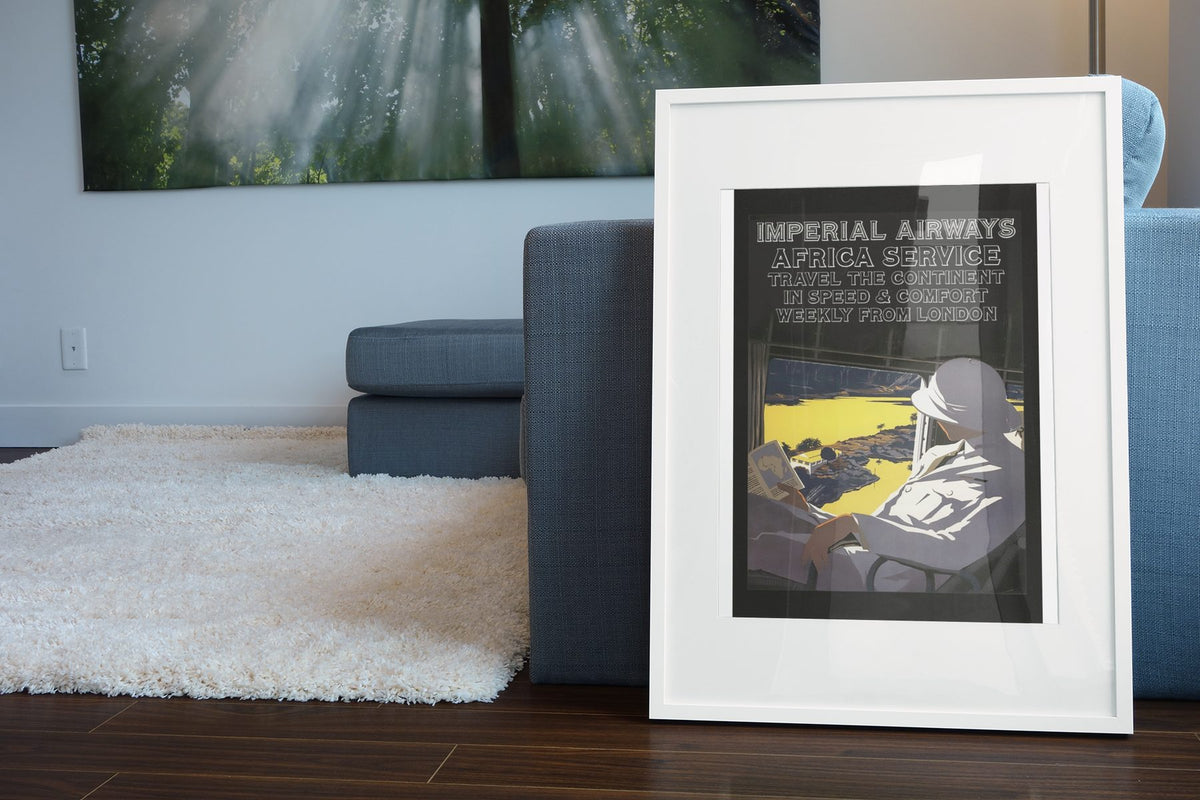 Imperial Airways Africa Service poster leaning beside a blue sofa