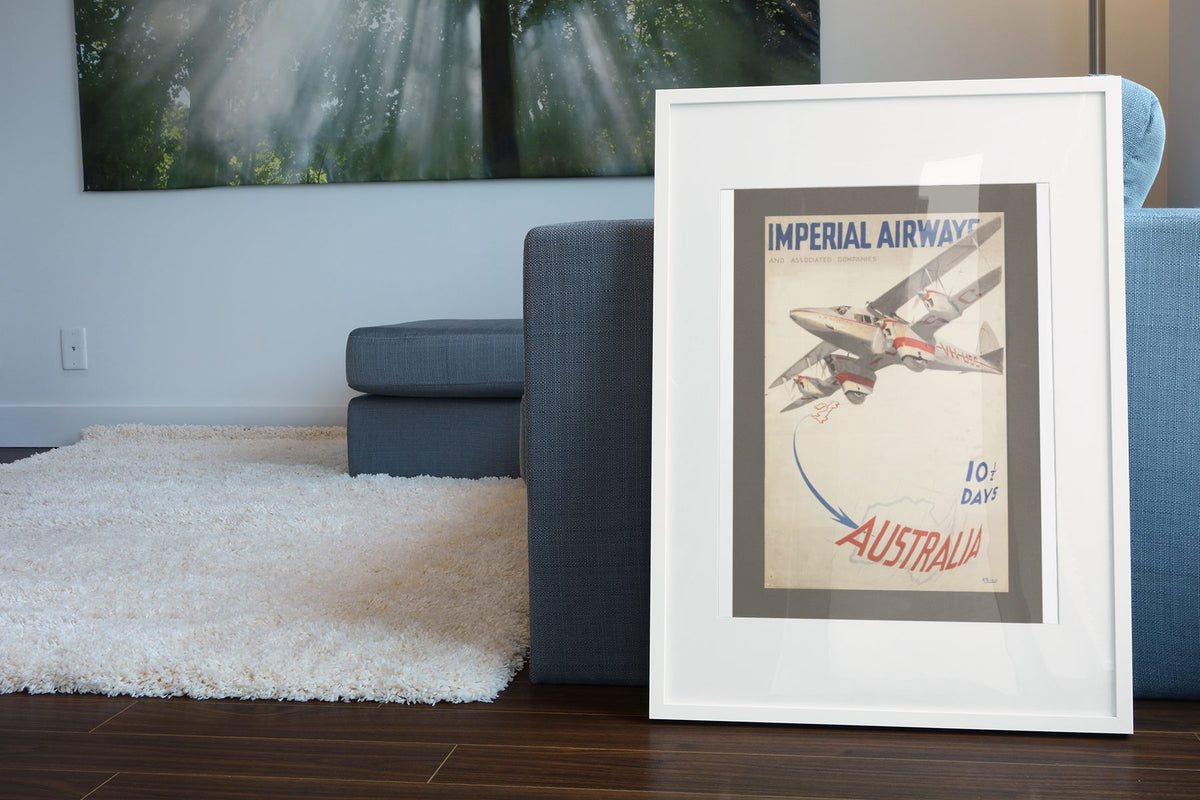 Imperial Airways Australia poster leaning beside a blue sofa