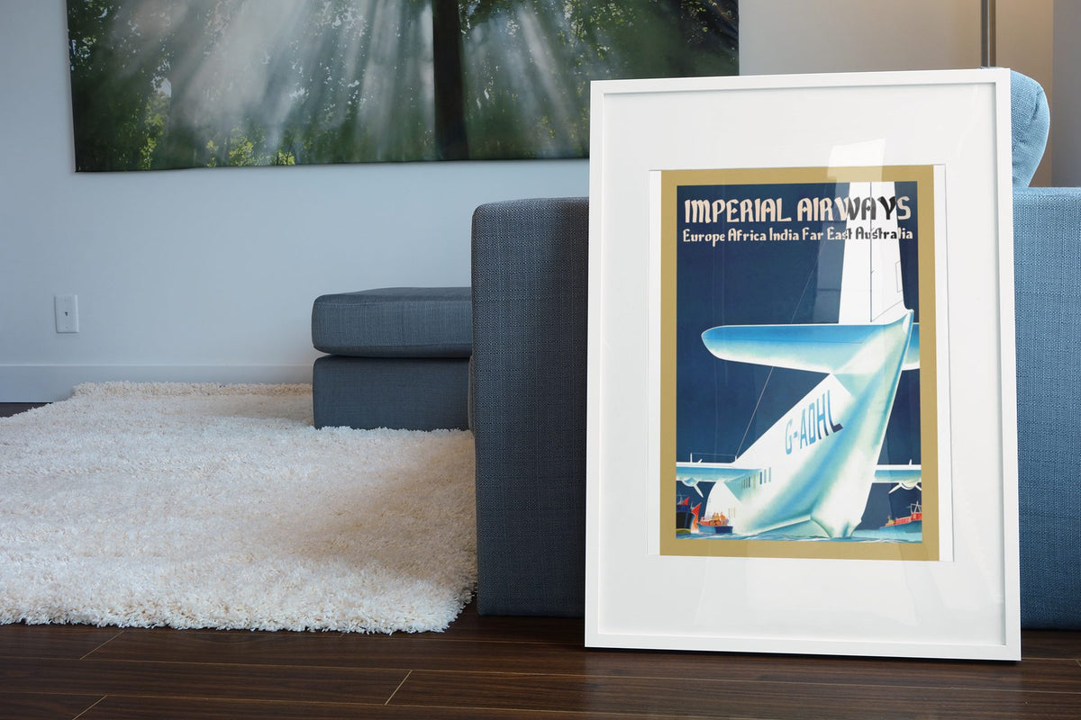 Imperial Airways Empire Routes poster leaning beside a blue sofa