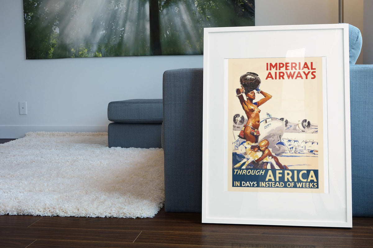 Imperial Airways Through Africa poster leaning beside a blue sofa