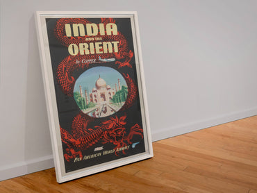 India and the Orient Pan Am poster in a white frame leaning against a wall
