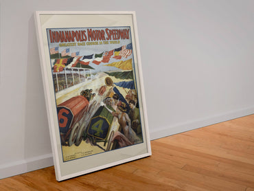 Indianapolis Motor Speedway poster in a white frame leaning against a wall