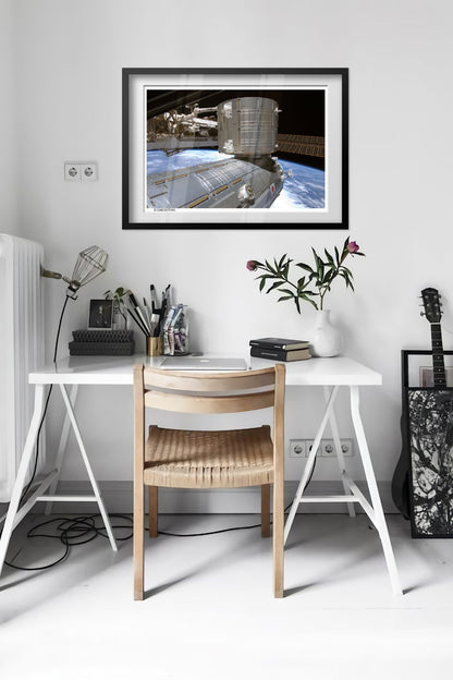 International Space Station over Earth poster framed in a bright home office