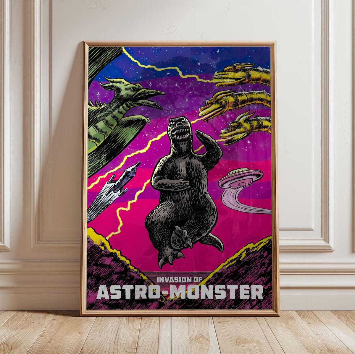 Invasion of Astro-Monster (1965) Movie Illustrated Art poster in a light oak frame leaning against a white wall