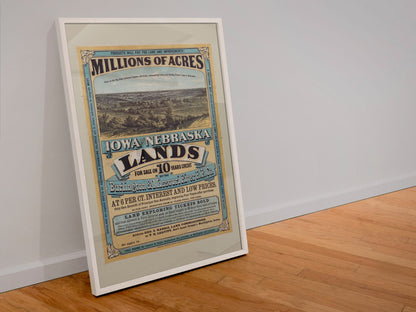 Iowa and Nebraska Lands for Sale poster in a white frame leaning against a wall