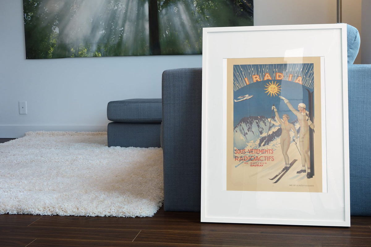 Iradia Radioactive Underwear poster leaning beside a blue sofa