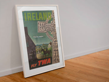 Ireland Fly TWA poster in a white frame leaning against a wall