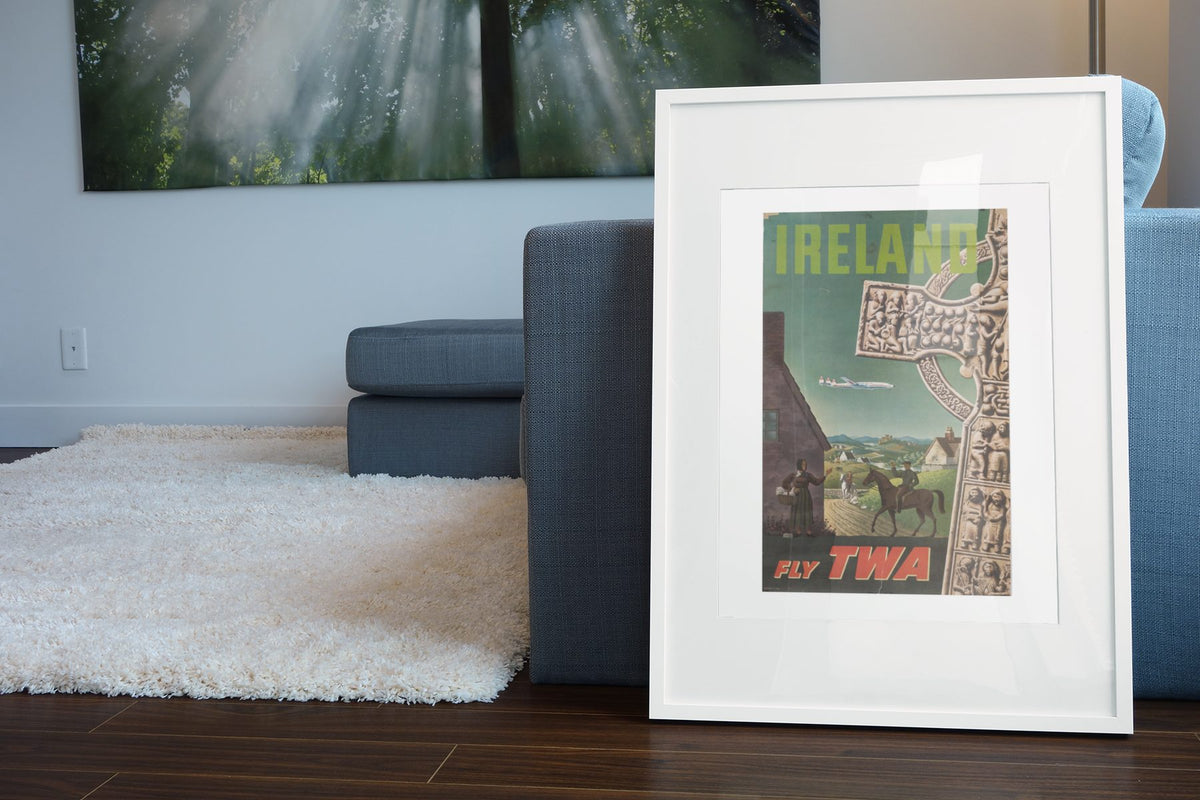 Ireland Fly TWA poster leaning beside a blue sofa