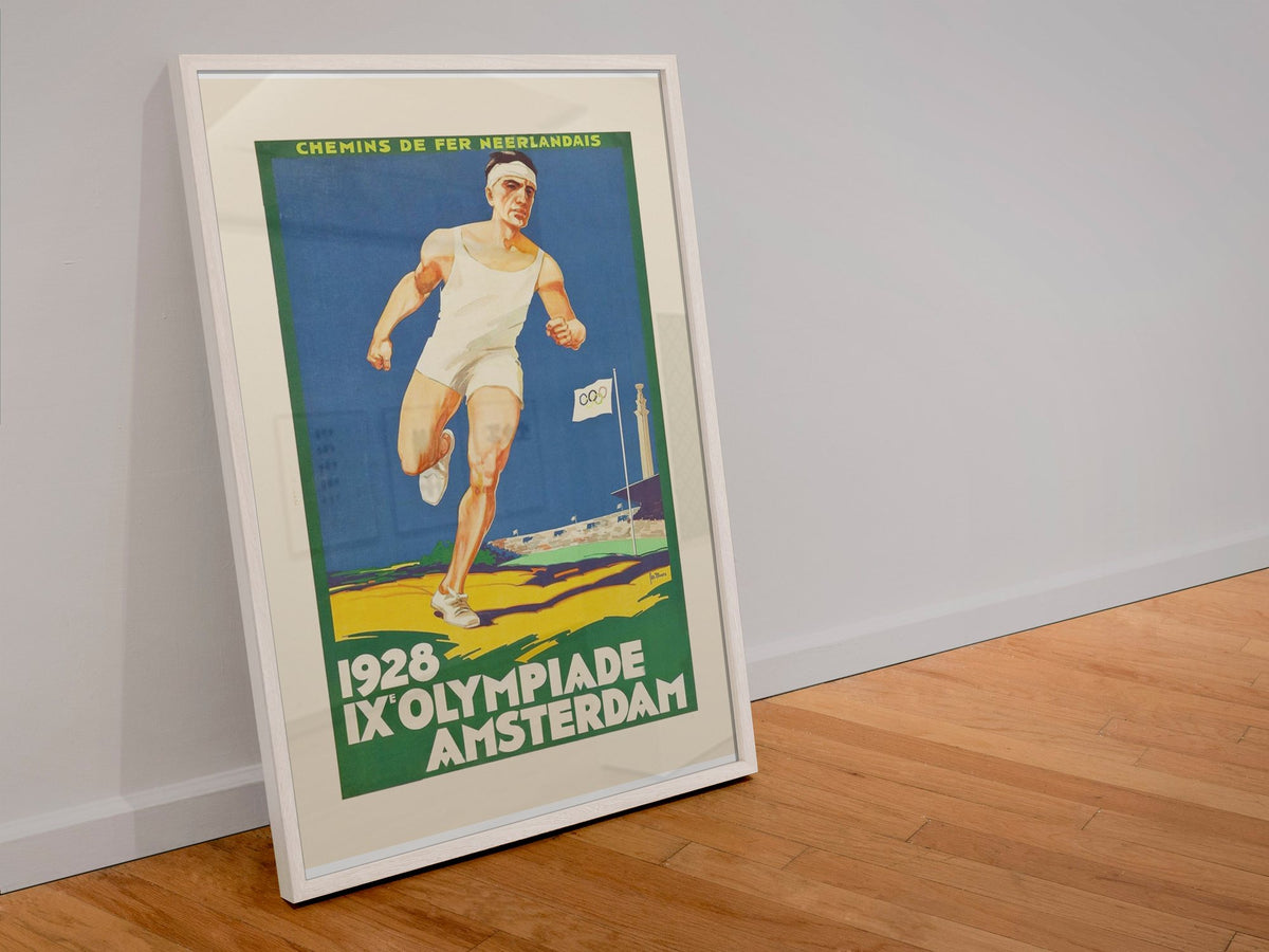 Amsterdam Olympics 1928 poster in a white frame leaning against a wall