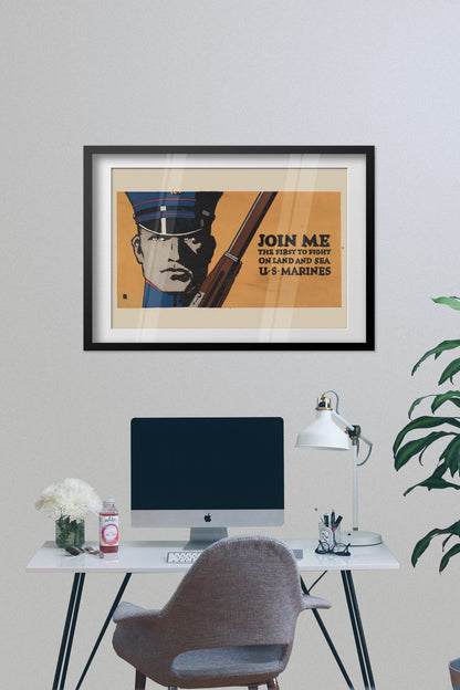 Join Me First to Fight US Marines poster framed on a grey wall above a desk
