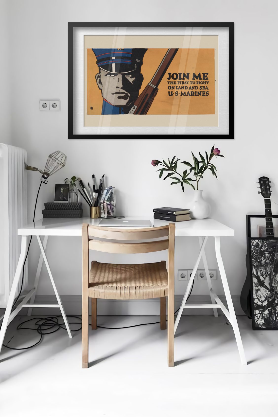 Join Me First to Fight US Marines poster framed above a desk in a bright white room
