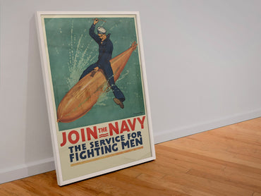 Join the Navy — The Service for Fighting Men poster in a white frame leaning against a wall