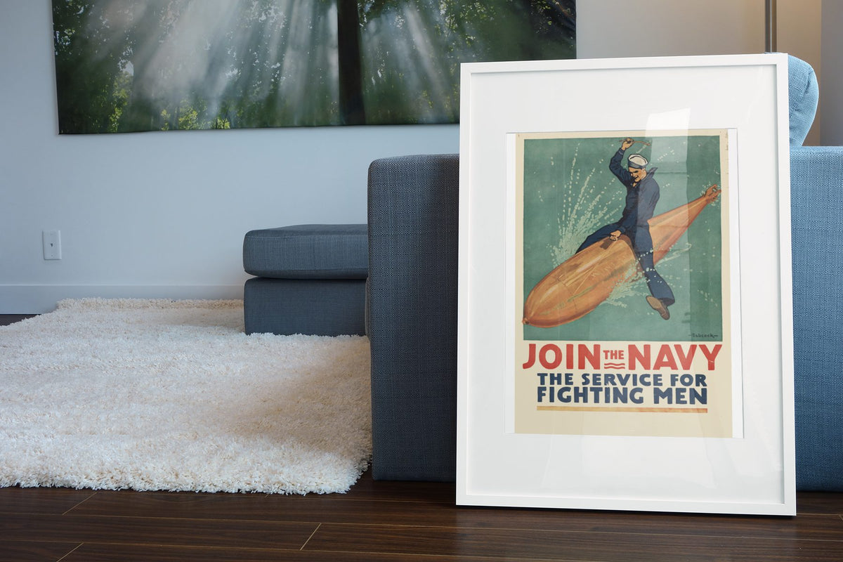 Join the Navy — The Service for Fighting Men poster leaning beside a blue sofa