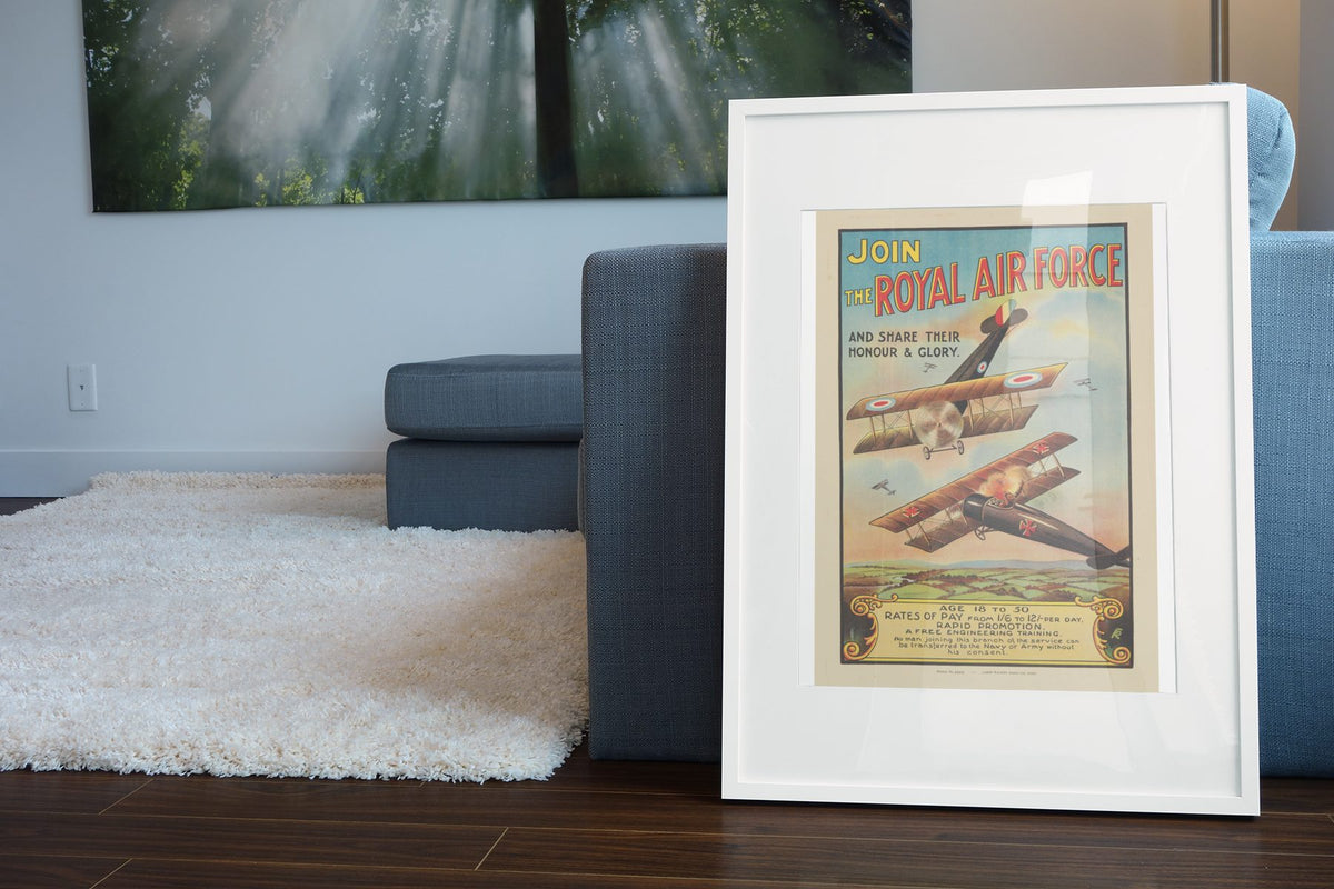 Join the Royal Air Force poster leaning beside a blue sofa