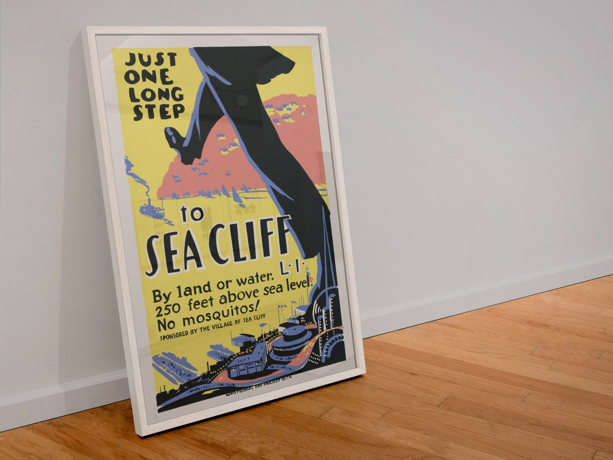 Just One Long Step to Sea Cliff poster in a white frame leaning against a wall