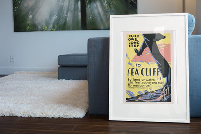 Just One Long Step to Sea Cliff poster leaning beside a blue sofa