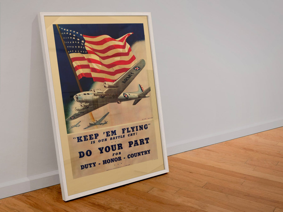 Keep Em Flying poster in a white frame leaning against a wall