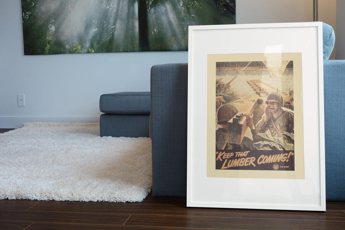 Keep That Lumber Coming poster leaning beside a blue sofa