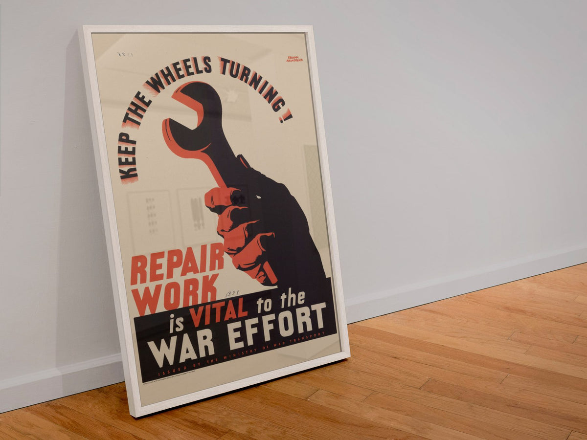 Keep the Wheels Turning Repair Work Is Vital poster in a white frame leaning against a wall