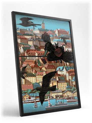 Kiki's Delivery Service Koriko Town Illustrated Art poster in a black frame with glass leaning against a wall