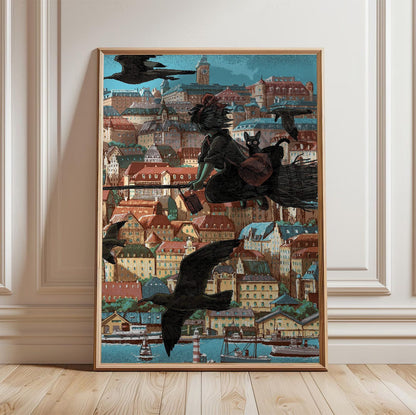 Kiki's Delivery Service Koriko Town Illustrated Art poster in a light oak frame leaning against a white wall