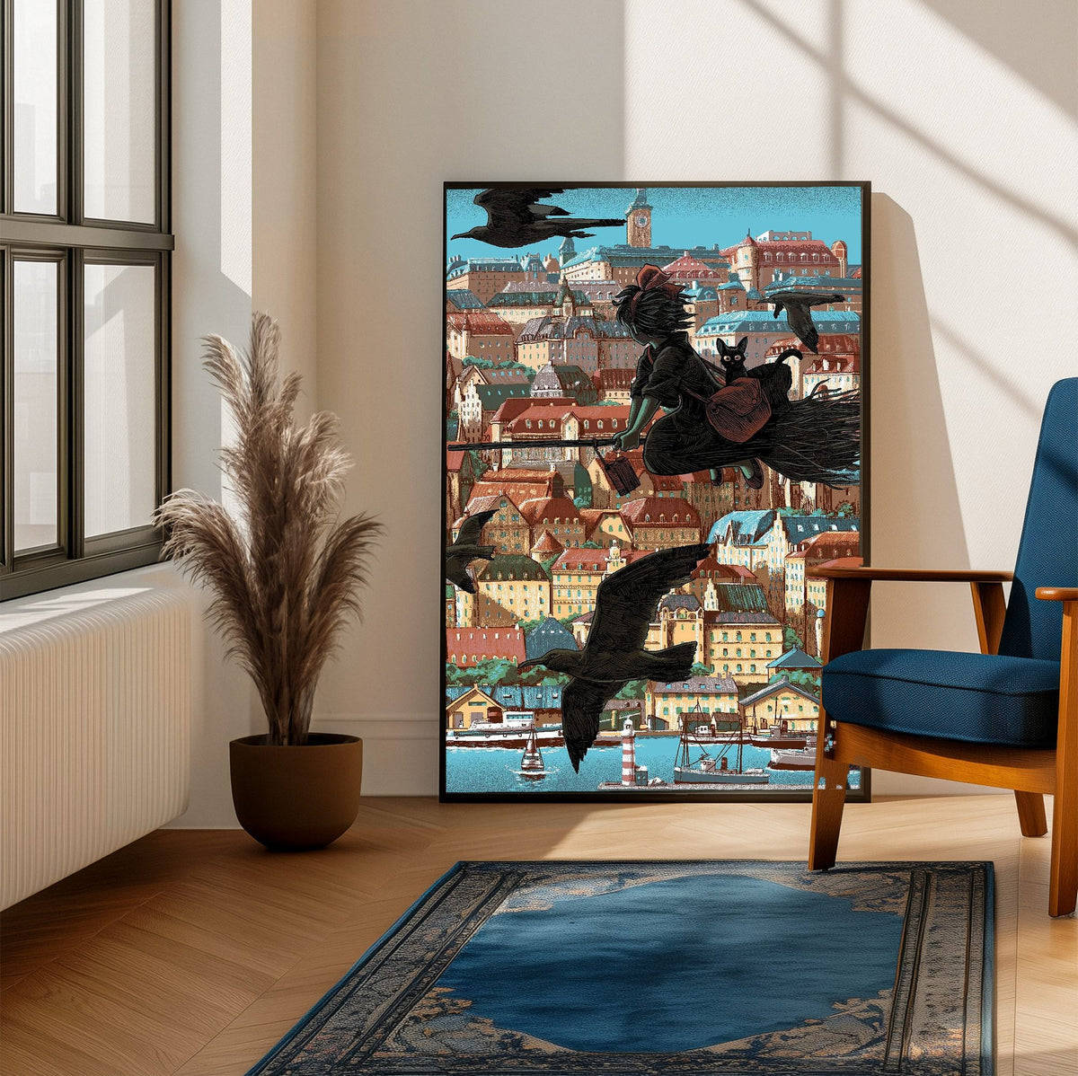 Kiki's Delivery Service Koriko Town Illustrated Art poster framed beside a blue armchair in a sunlit room