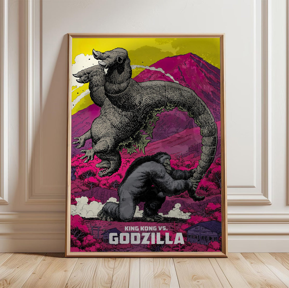 King Kong vs. Godzilla (1962) Movie Pop Art poster in a light oak frame leaning against a white wall