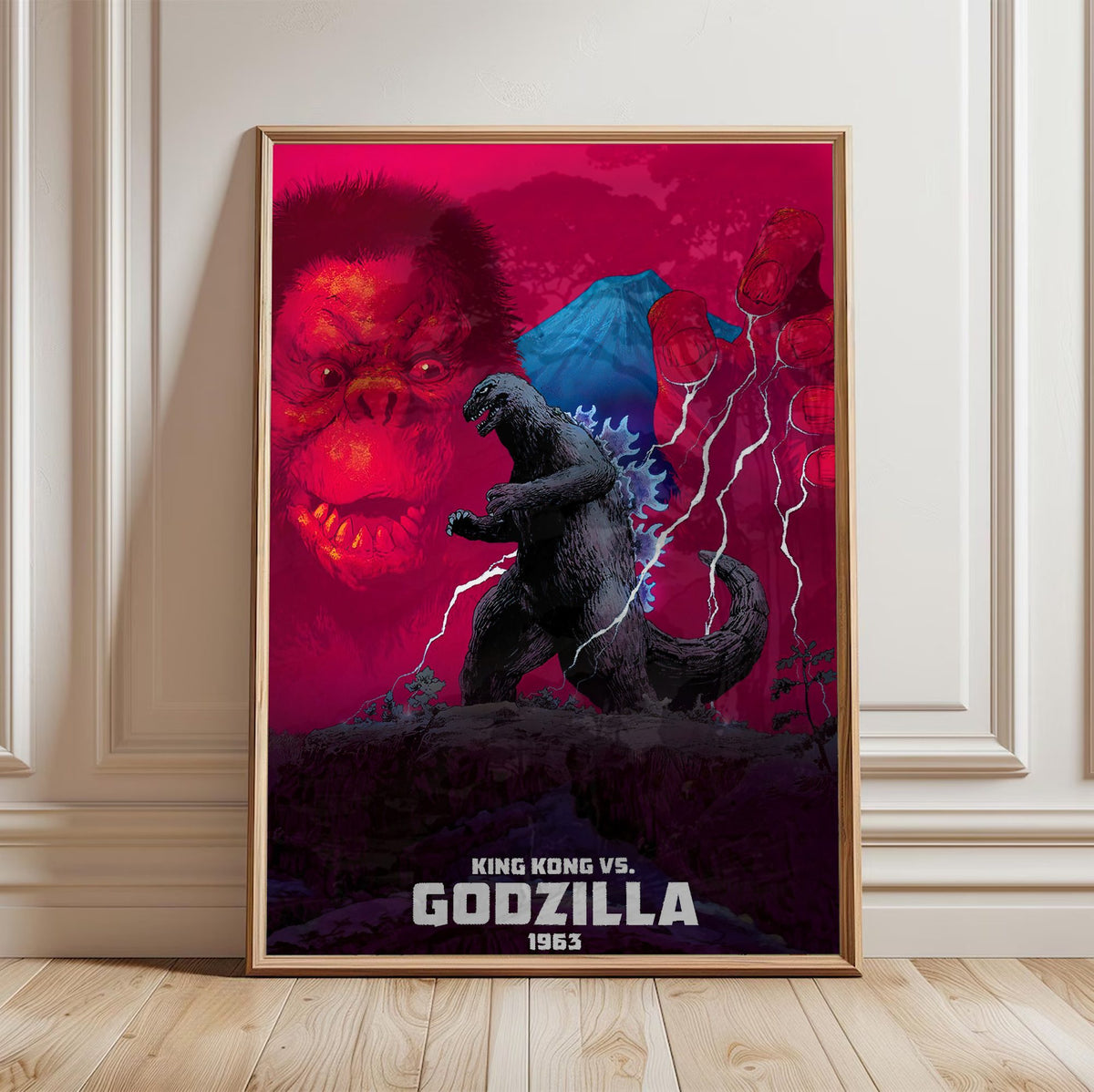 King Kong vs. Godzilla (1963) Movie Red Pop Art poster in a light oak frame leaning against a white wall