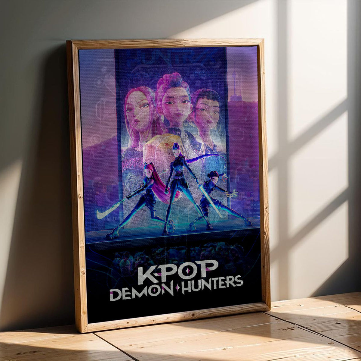 KPop Demon Hunters (2025) Movie Huntrix Key Art poster in an oak frame leaning on a wooden floor