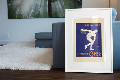 La Bicyclette Esper poster leaning beside a blue sofa