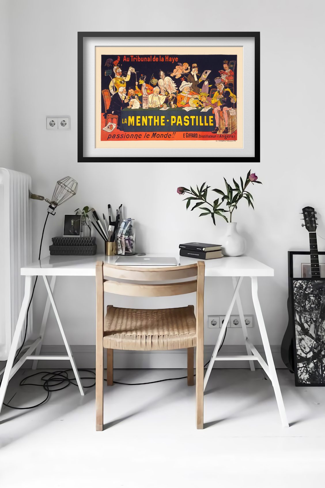 La Menthe-Pastille poster framed above a desk in a bright white room