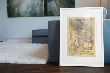 La Peoria Bicyclette poster leaning beside a blue sofa