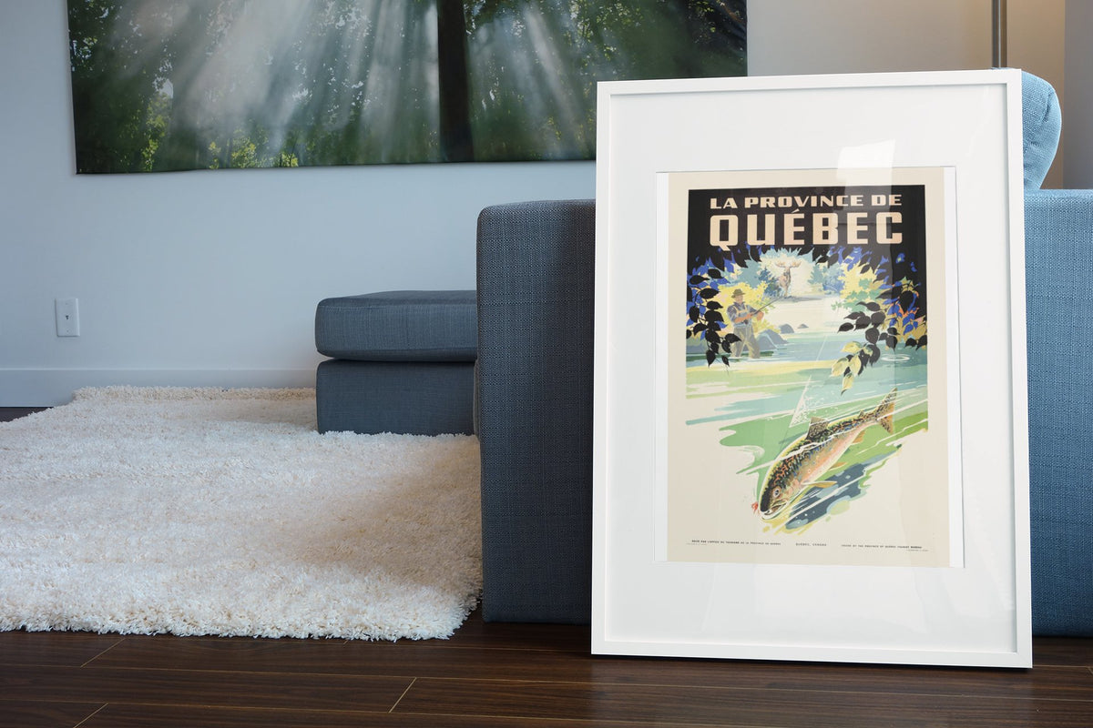 Quebec Trout Fishing poster leaning beside a blue sofa