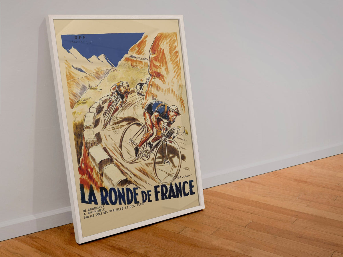 La Ronde de France poster in a white frame leaning against a wall