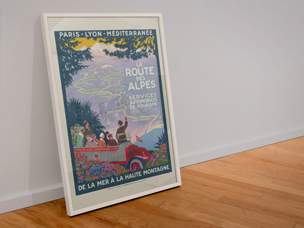 La Route des Alpes poster in a white frame leaning against a wall