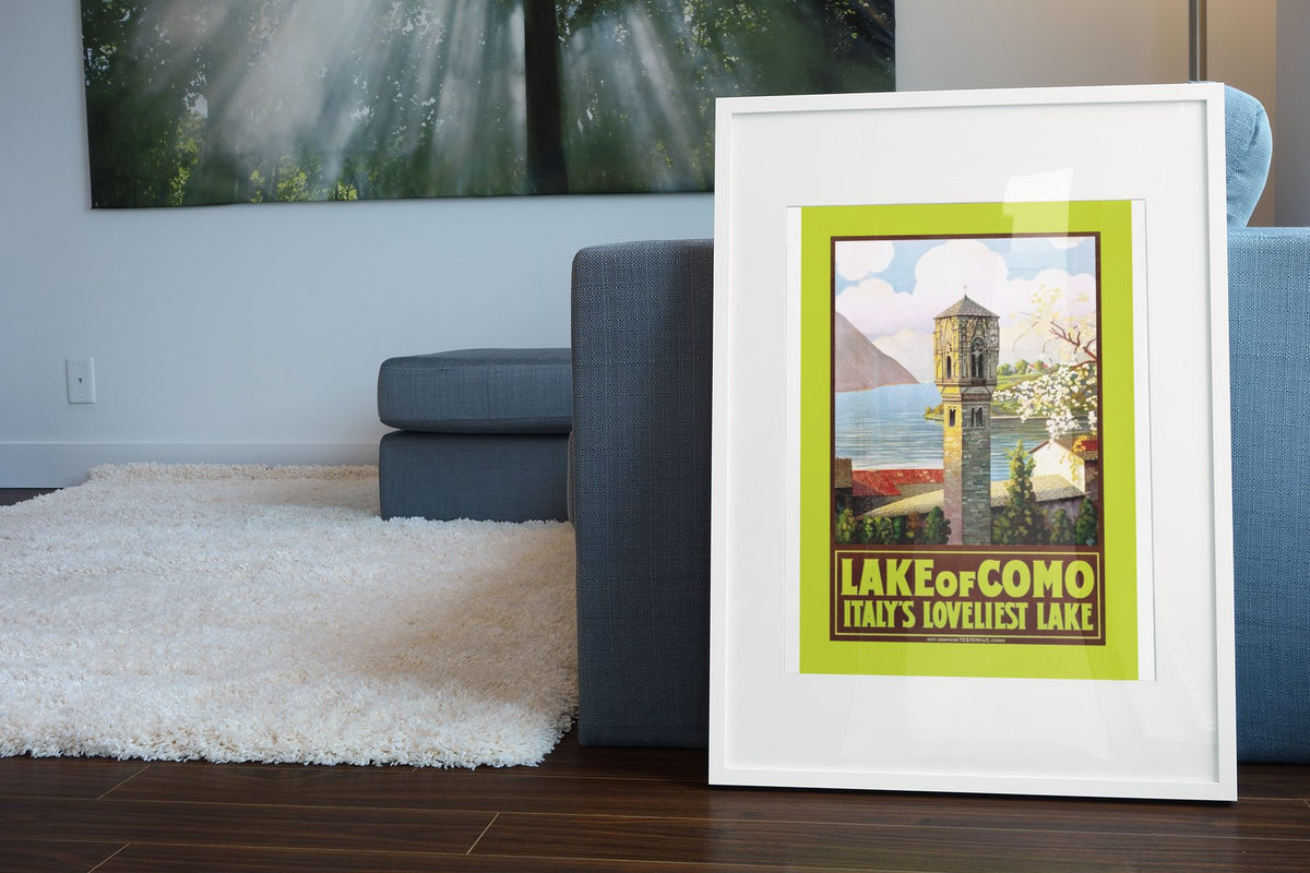 Lake Como Italys Loveliest Lake poster leaning beside a blue sofa