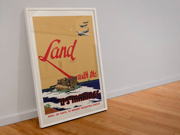 Land with the U.S. Marines poster in a white frame leaning against a wall