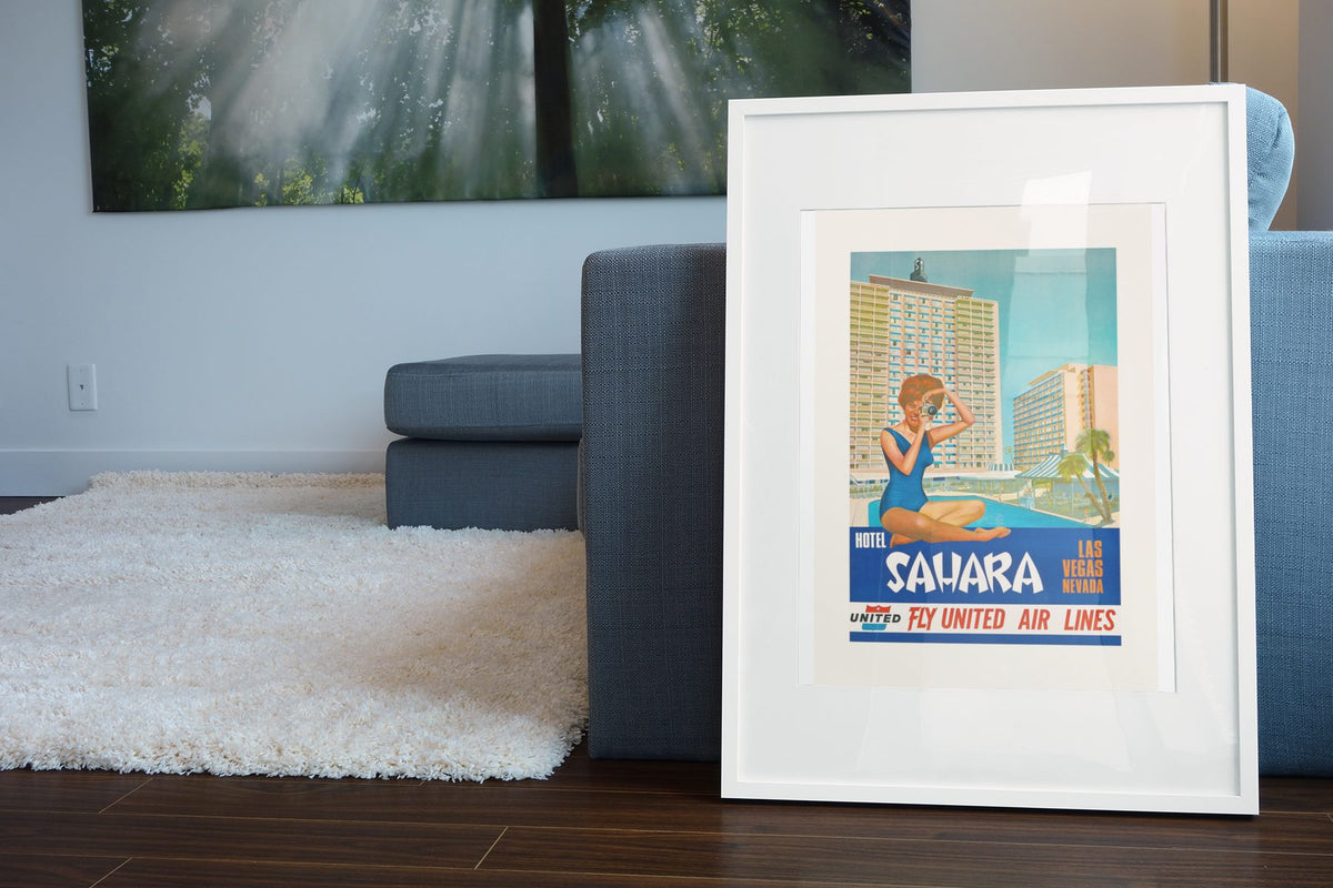 Las Vegas Sahara Hotel poster leaning beside a blue sofa