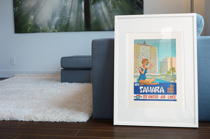 Las Vegas Sahara Hotel poster leaning beside a blue sofa