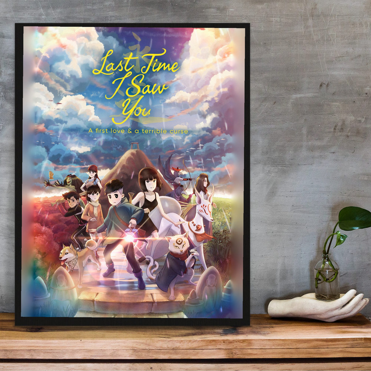 Last Time I Saw You Key Art poster in a black frame on a wooden shelf against concrete