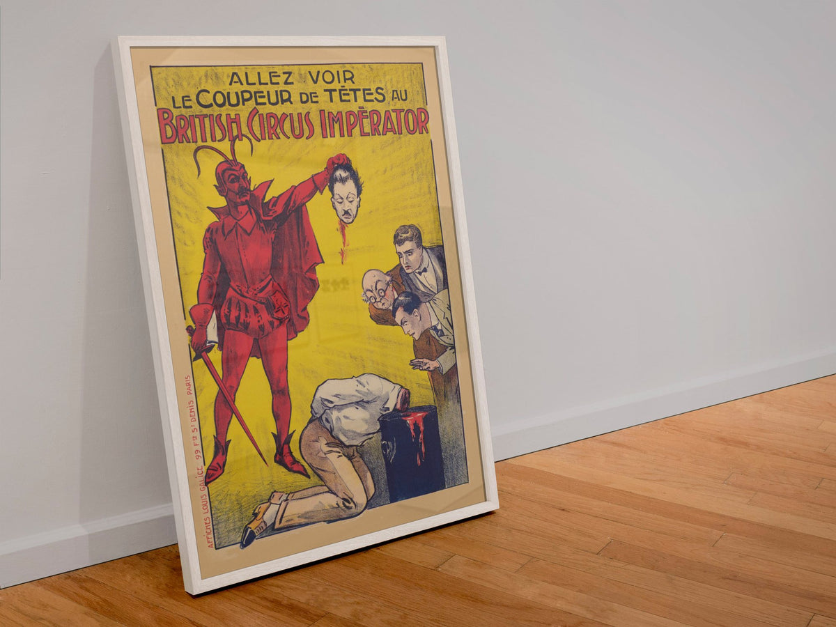 Le Coupeur de Tetes devil headsman poster in a white frame leaning against a wall