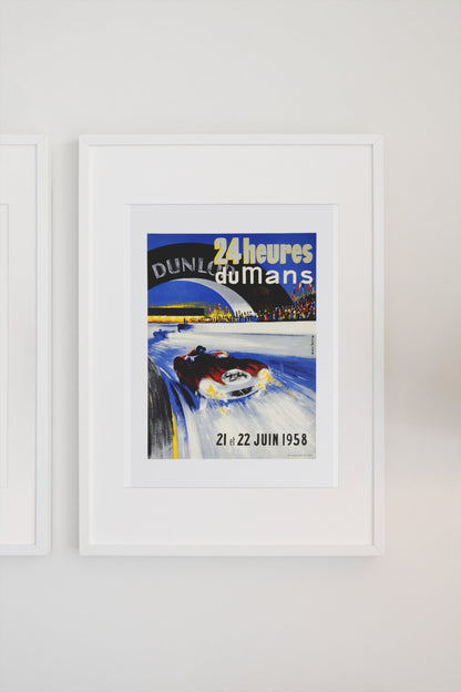 24 Heures du Mans 1958 poster in a white frame on a light wall
