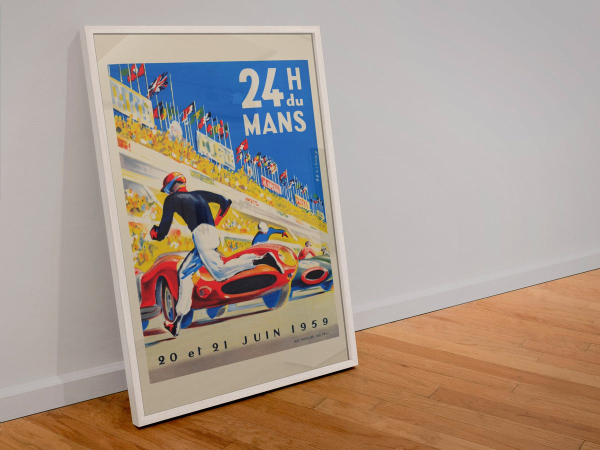 24 Heures du Mans 1959 poster in a white frame leaning against a wall