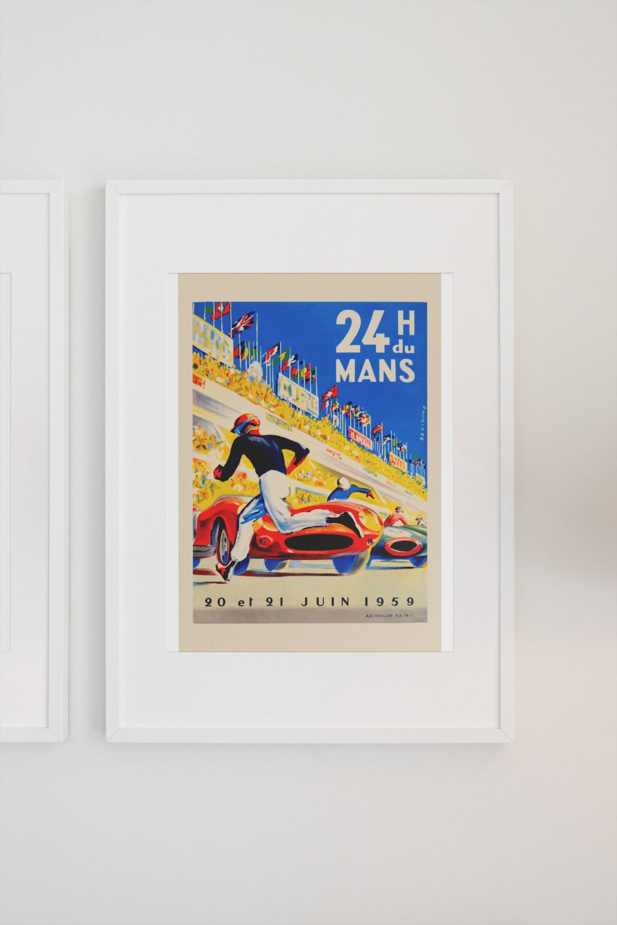 24 Heures du Mans 1959 poster in a white frame on a light wall