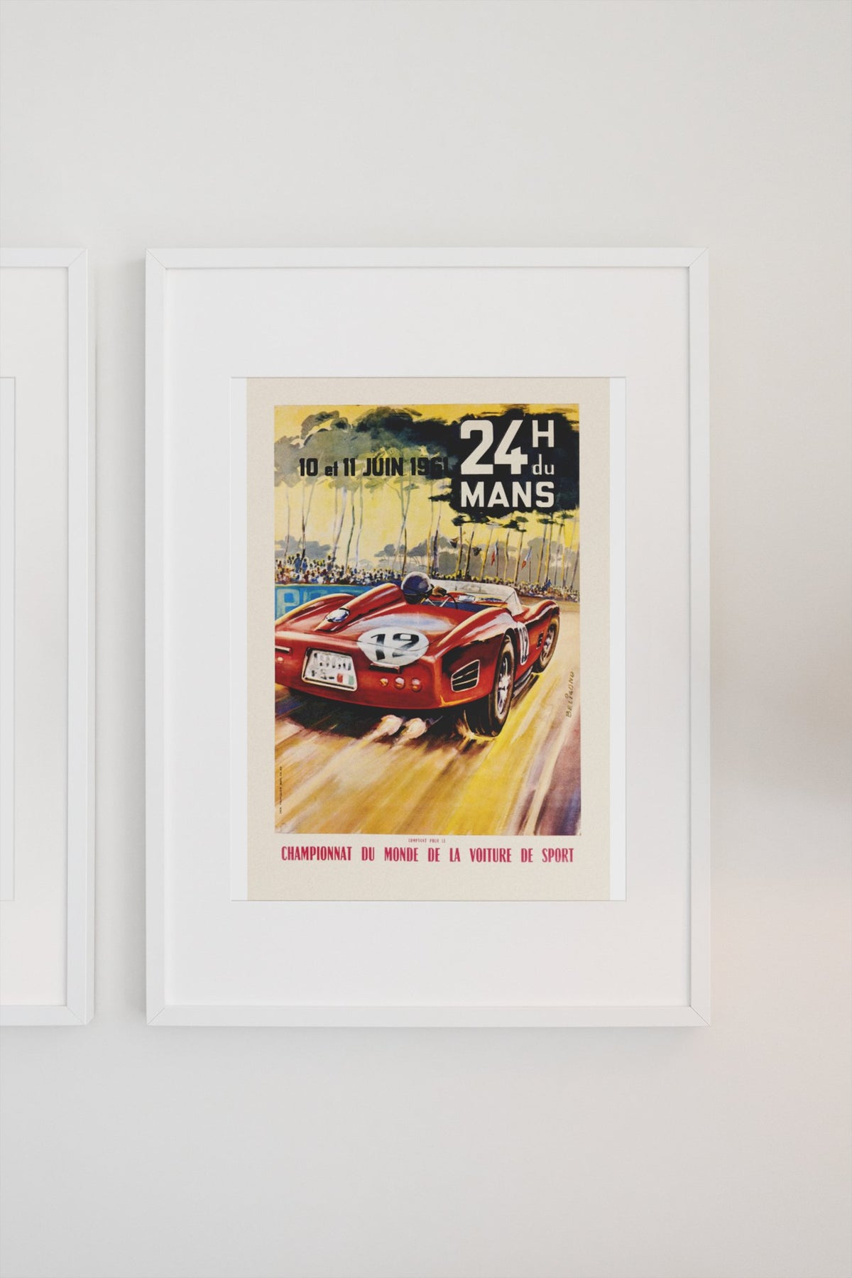 24 Heures du Mans 1961 poster in a white frame on a light wall
