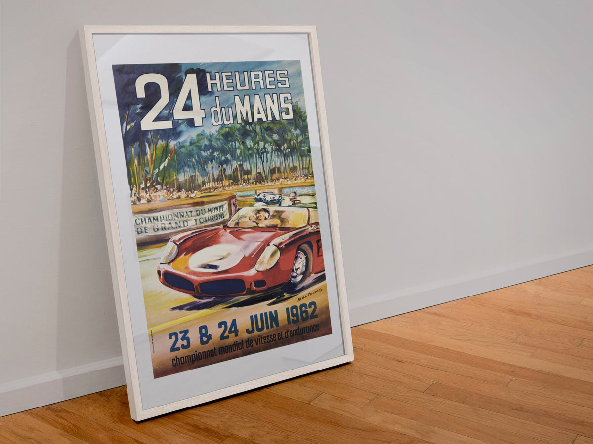 24 Heures du Mans 1962 poster in a white frame leaning against a wall