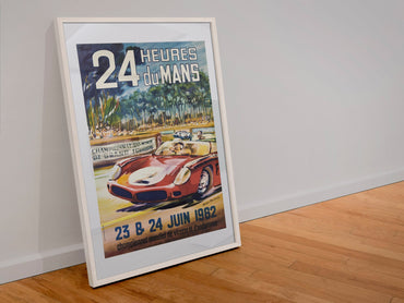 24 Heures du Mans 1962 poster in a white frame leaning against a wall